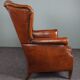Eared armchair in patinated sheepskin