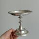 Silver-plated metal stand.