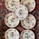 7 hand-painted flowered dinner plates.