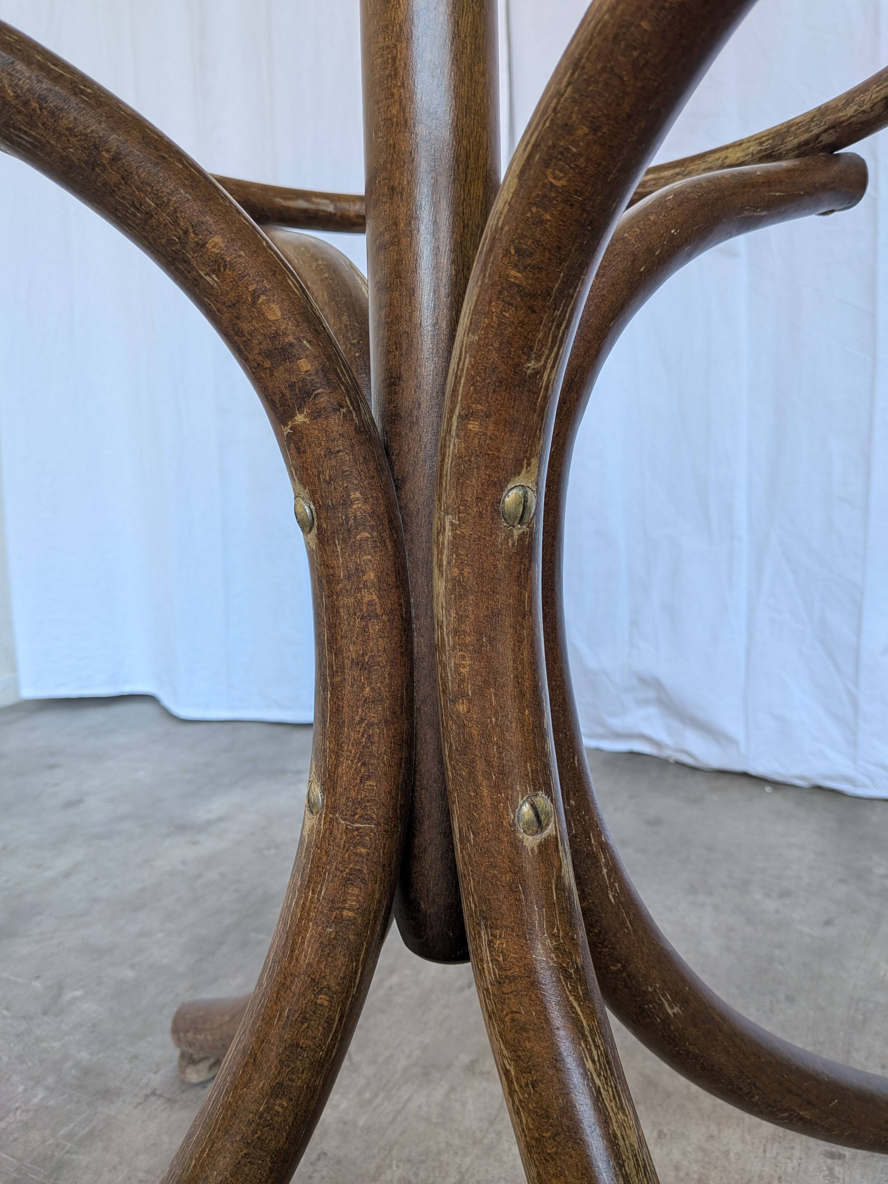Vintage bentwood coat rack in Thonet style / Dark wood coat rack with shadow.