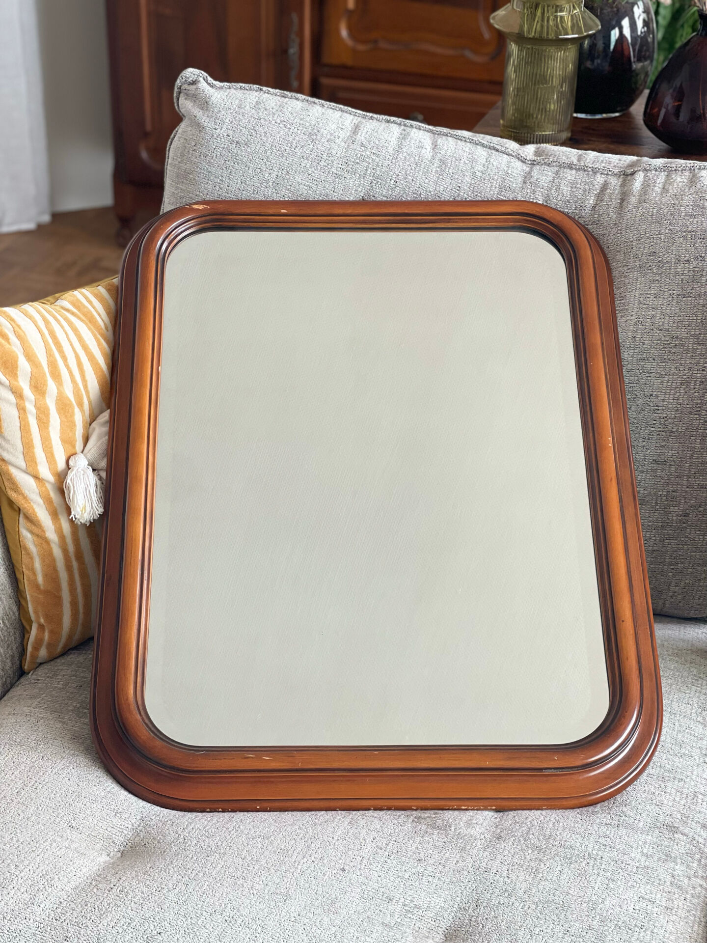 Vintage wooden framed mirror with bevelled glass.