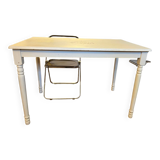 Farm table with a cream patina.