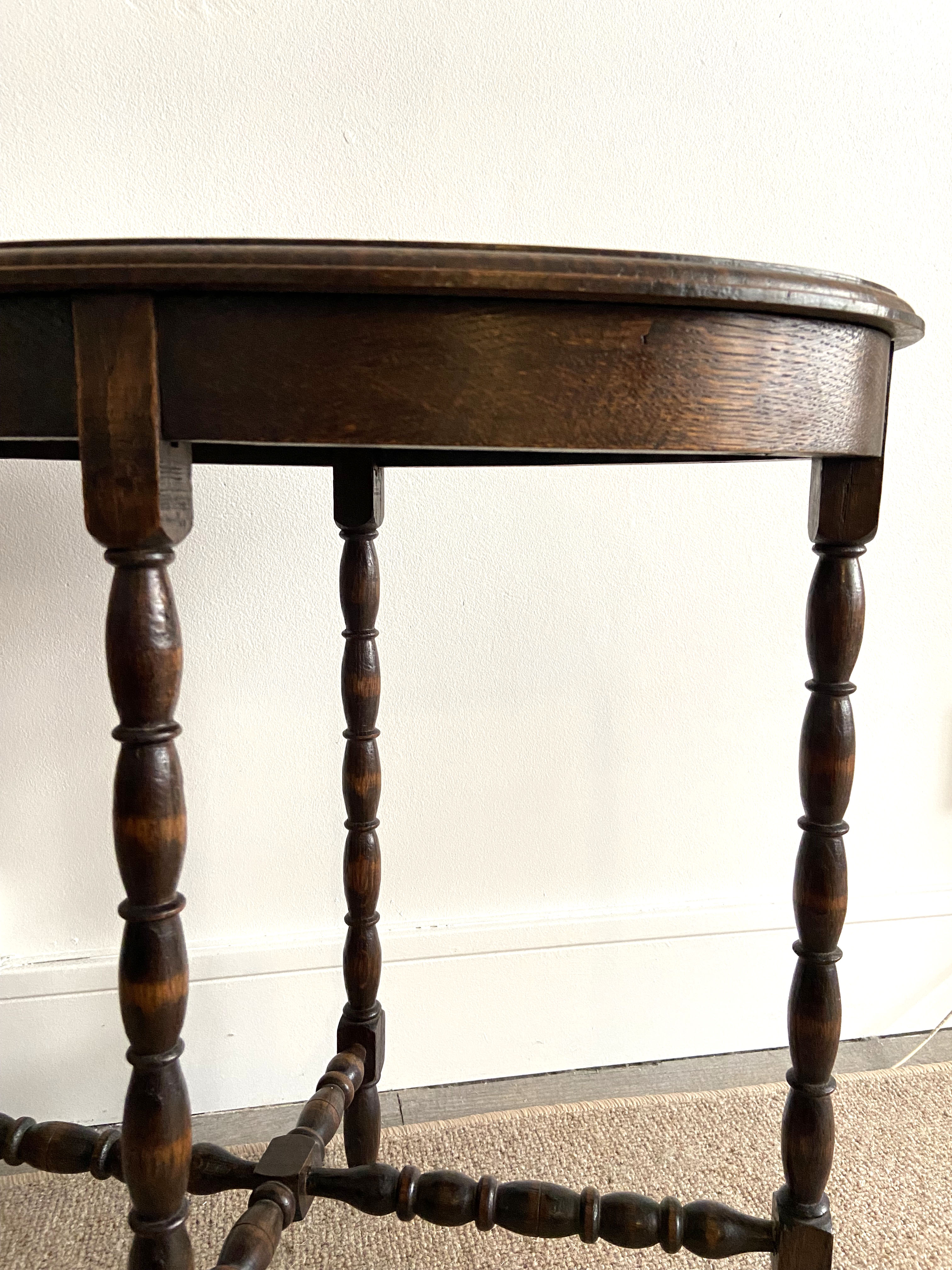 Oval wooden side table turned with spacer