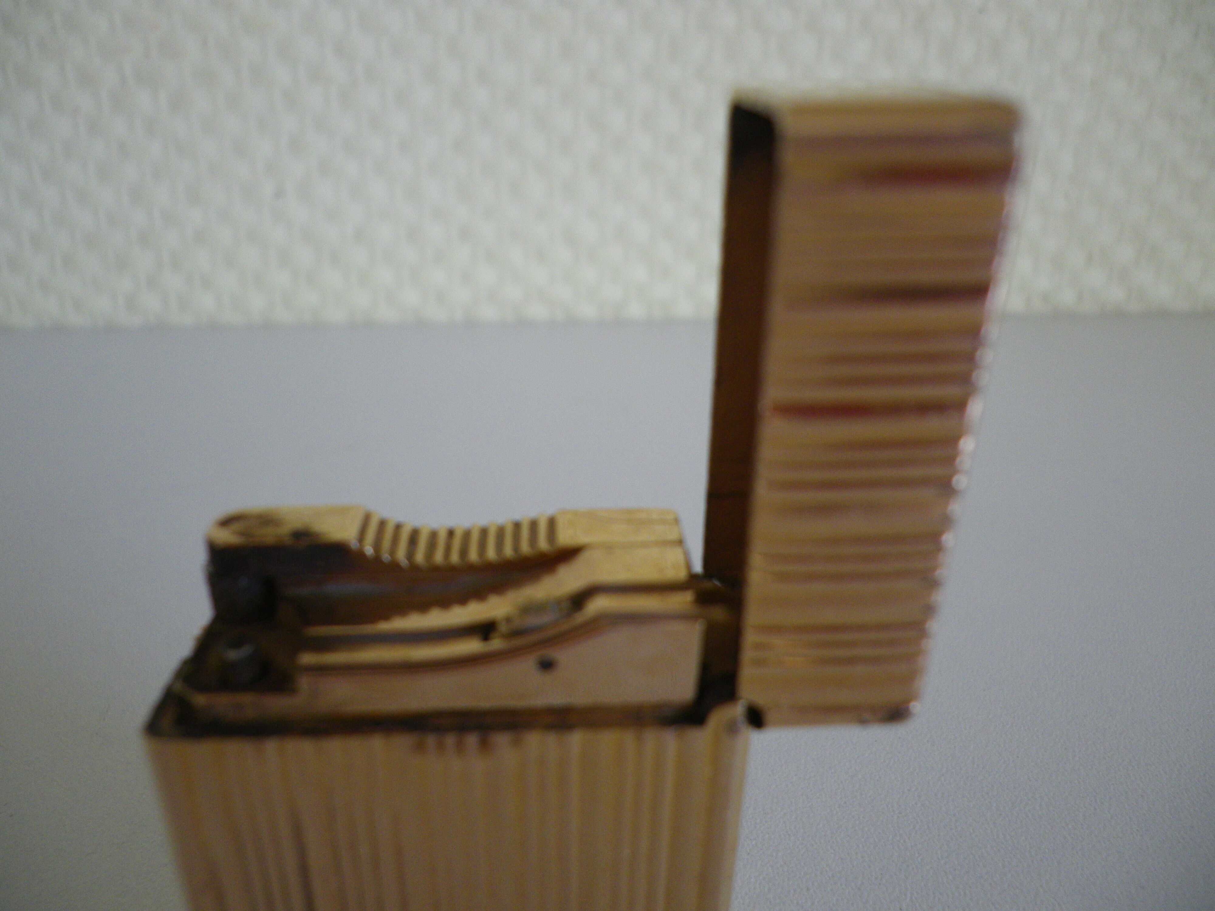 2 st dupont lighters, gold plated, punches, numbered, 1 striated pattern, 1 hammered pattern, 70s