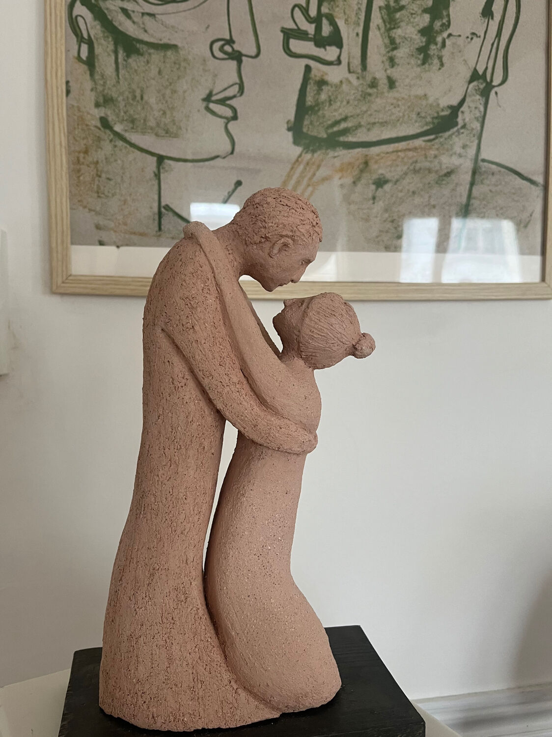 Terracotta sculpture of an entwined couple.