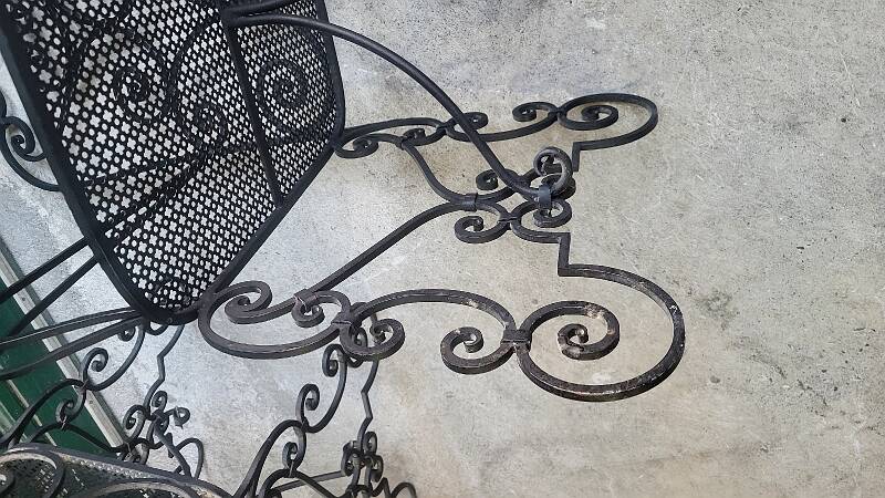 Pair of black wrought iron armchairs
