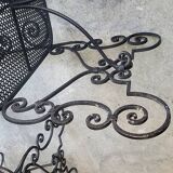 Pair of black wrought iron armchairs
