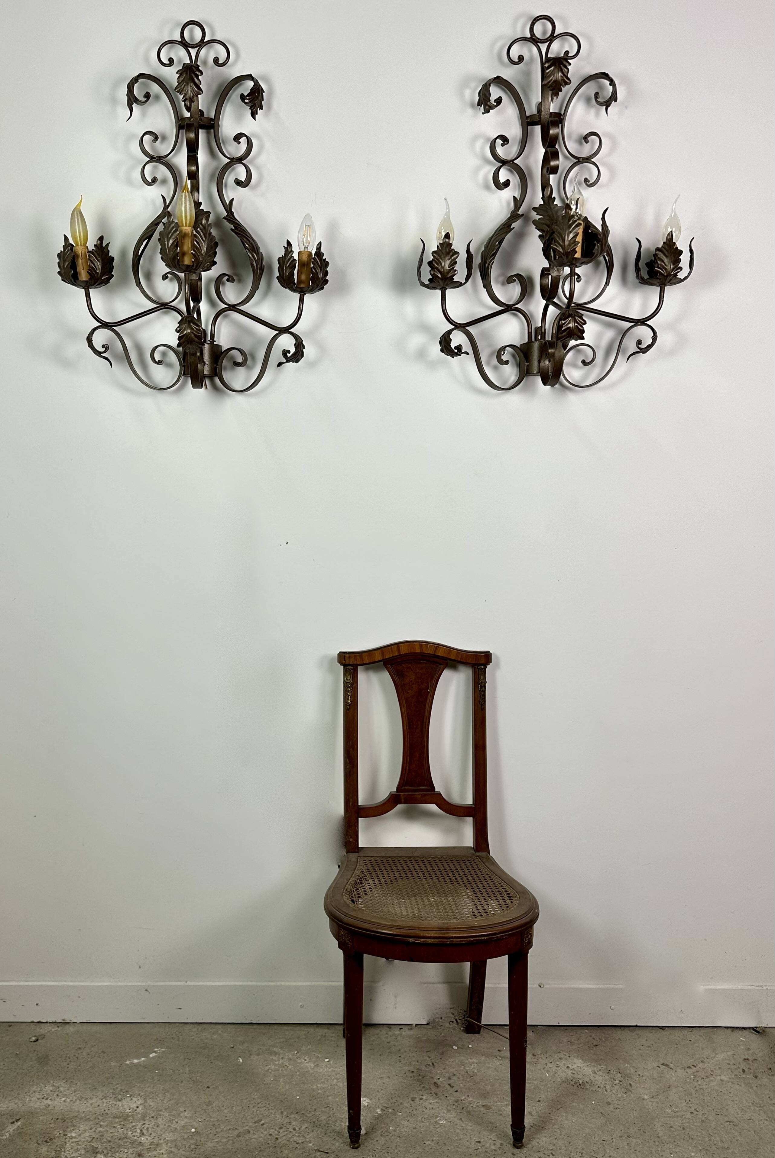Wrought iron wall lights (pair) with foliage decoration