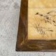 Vintage 70s coffee table with wood and ceramic tiles featuring bird and nature patterns.