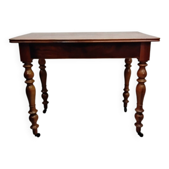 Antique wooden desk with a drawer.