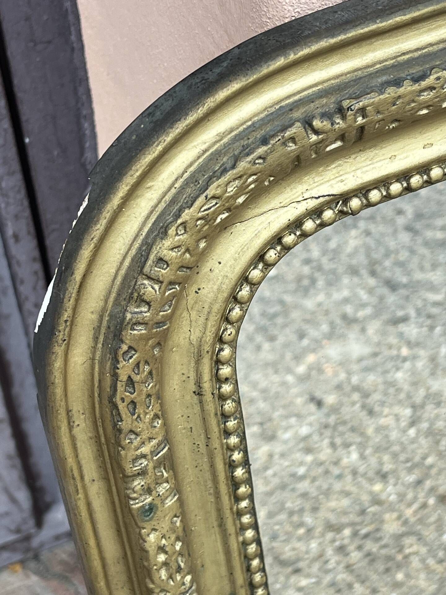 Louis Philippe mirror in gilded wood with an openwork frieze.