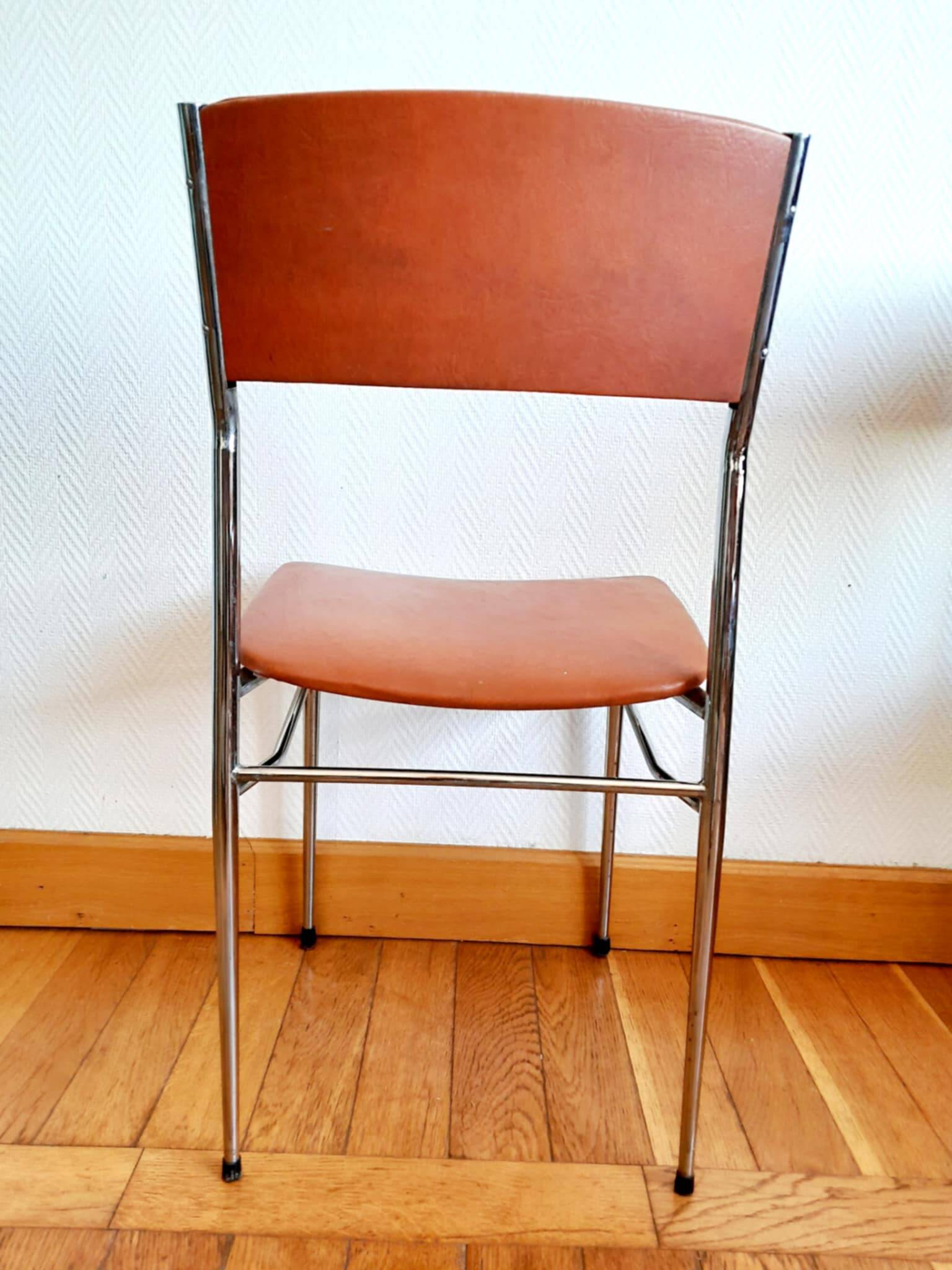 Three mid-century chairs in faux leather and chrome from the 1950s.