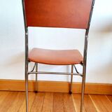 Three mid-century chairs in faux leather and chrome from the 1950s.