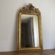 Late 19th century gilded mirror with decorated pediment. 125x70.