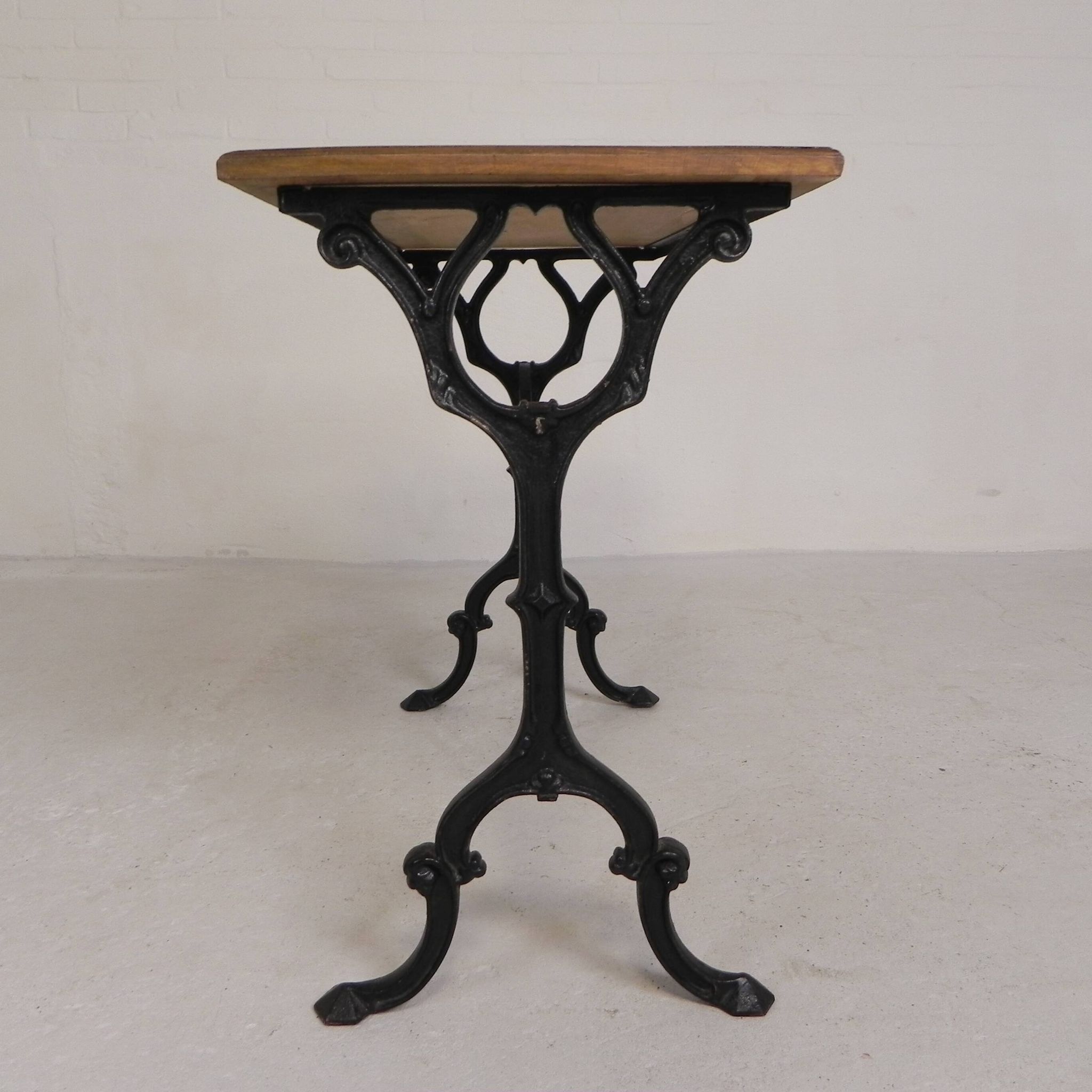 Bistro table with an oak top on a cast iron base, 1930s.