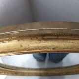 Golden oval mirror