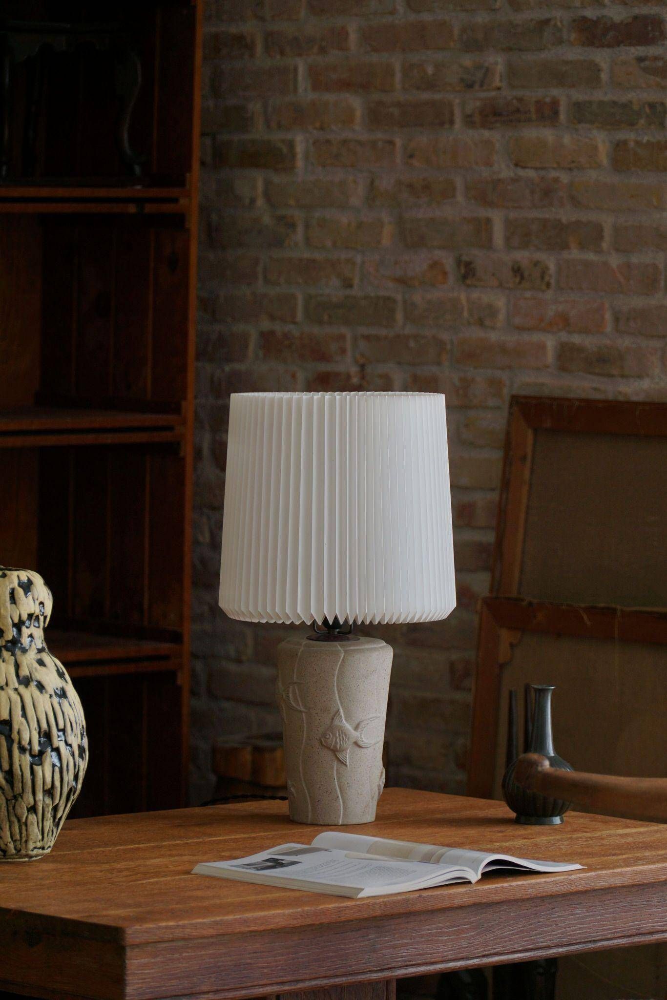 Modern vintage French table lamp, made of stone with fish patterns, 1970s.