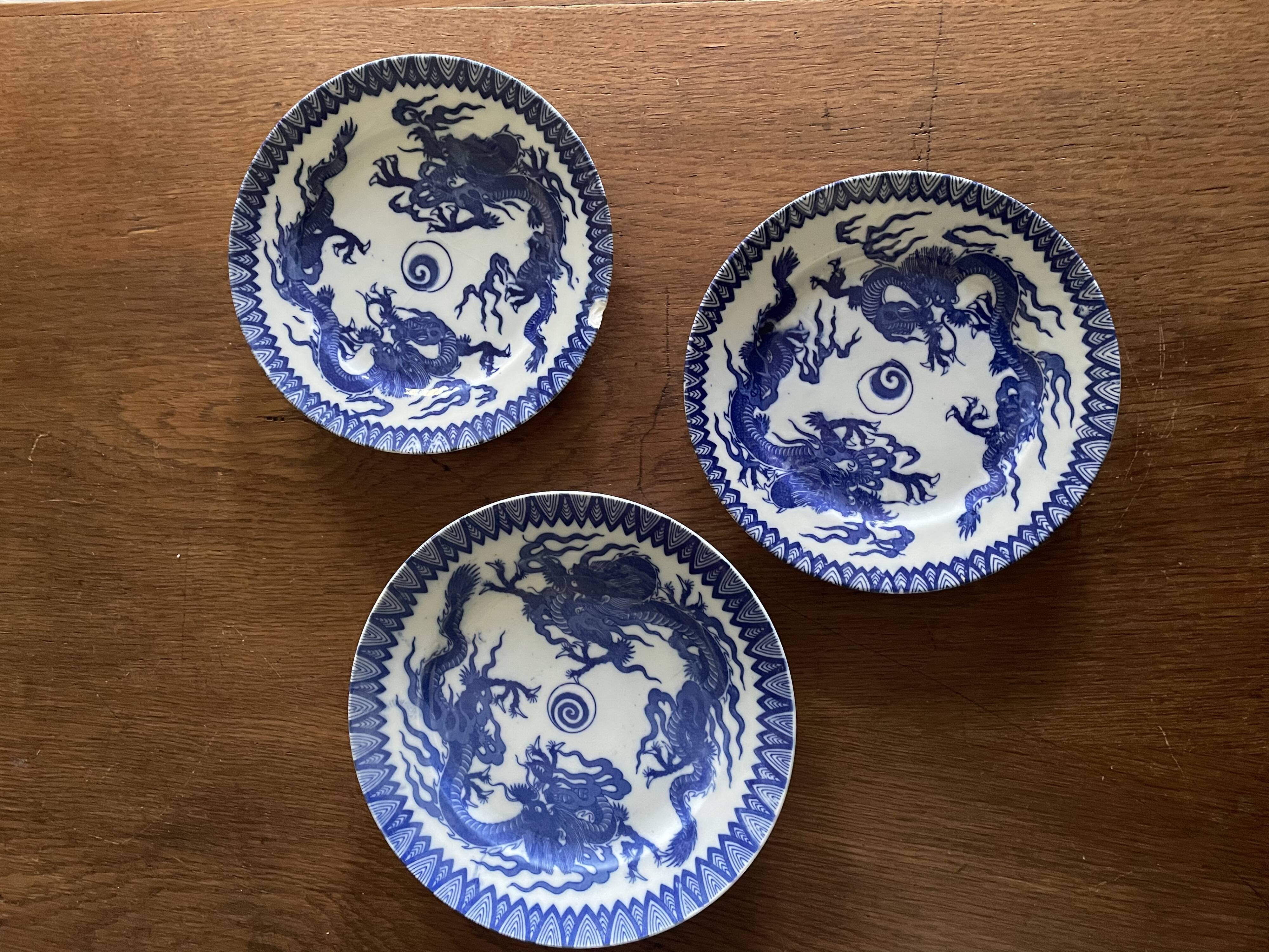 Asian porcelain plates decorated with blue dragons