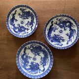 Asian porcelain plates decorated with blue dragons