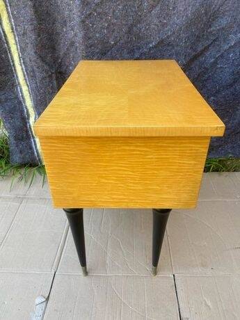 Vintage wooden bedside table from the 50s-60s with black tapered legs and brass tips.