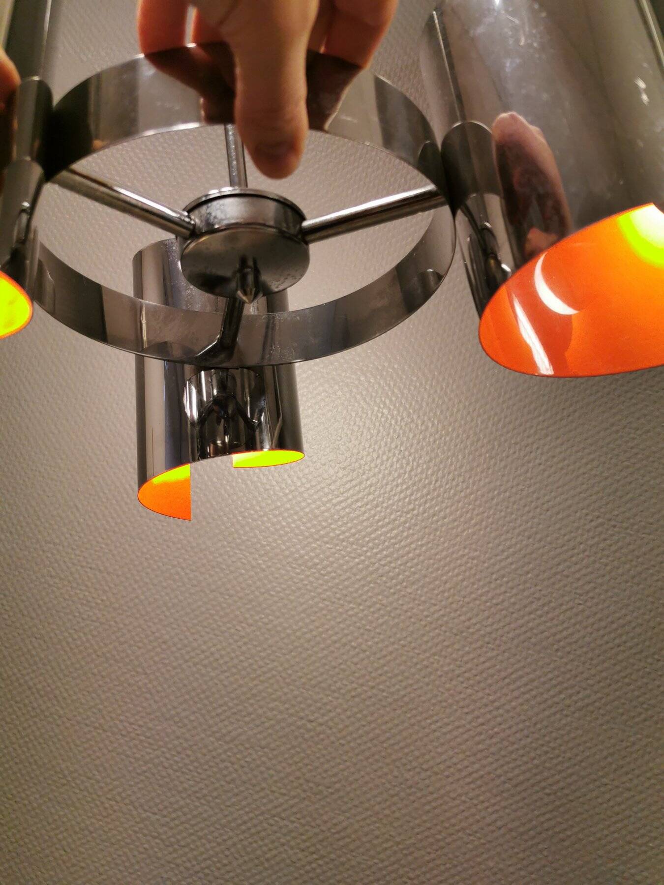 Hanging lamp in chromed metal with orange contrast lacquer and three light sources.