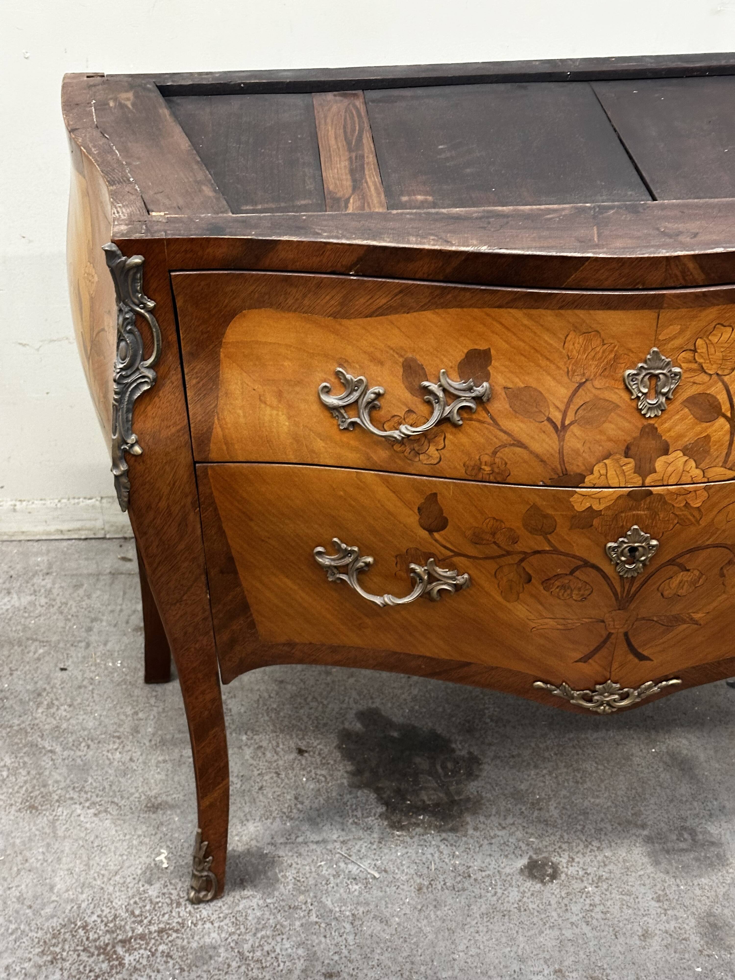 Curved and inlaid Louis XV style chest of drawers