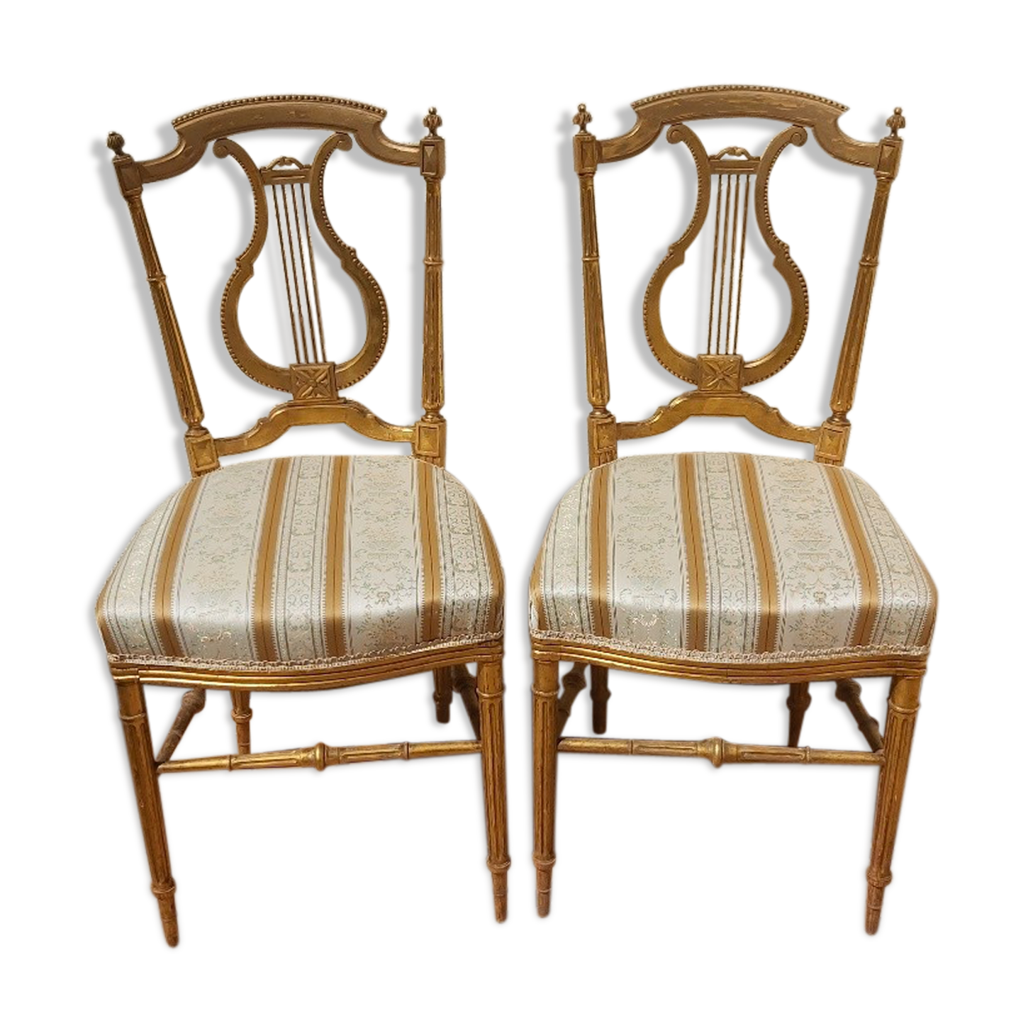 Pair of chairs with a golden lyre