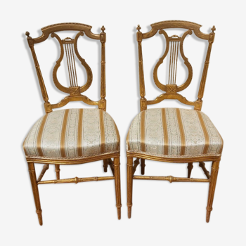 Pair of chairs with a golden lyre