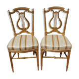 Pair of chairs with a golden lyre