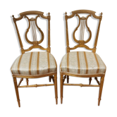 Pair of chairs with a golden lyre