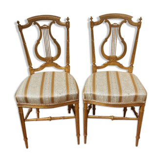 Pair of chairs with a golden lyre