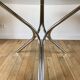 Set consisting of a table in chrome and smoked glass and its 4 tubular chairs in chrome and skaï a