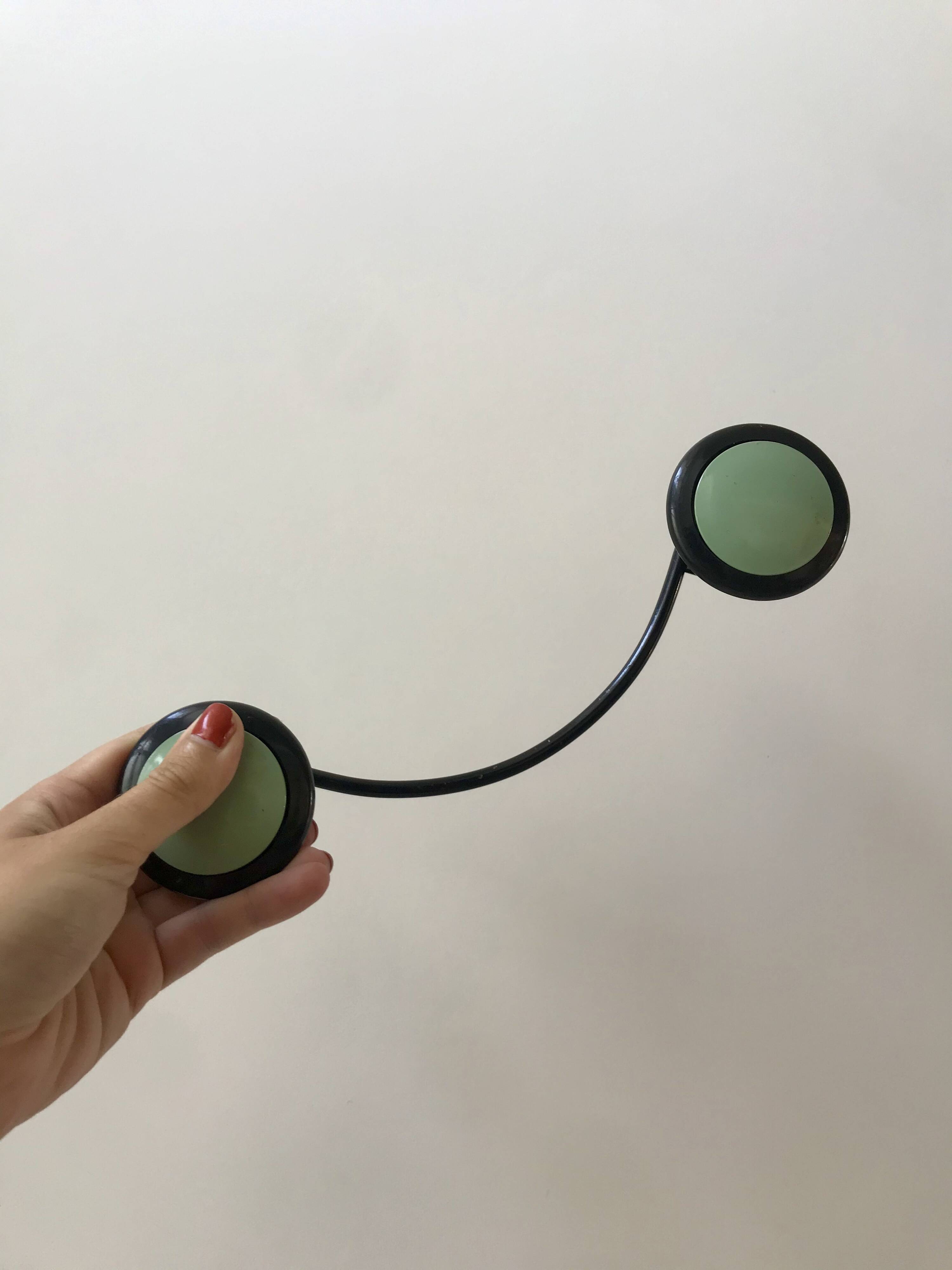 Design coat hook in sage green and black metal from the 70s