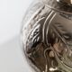 Vintage Italian vase in nickel-plated brass from the 1960s, hand-hammered relief of fruits and leaves.