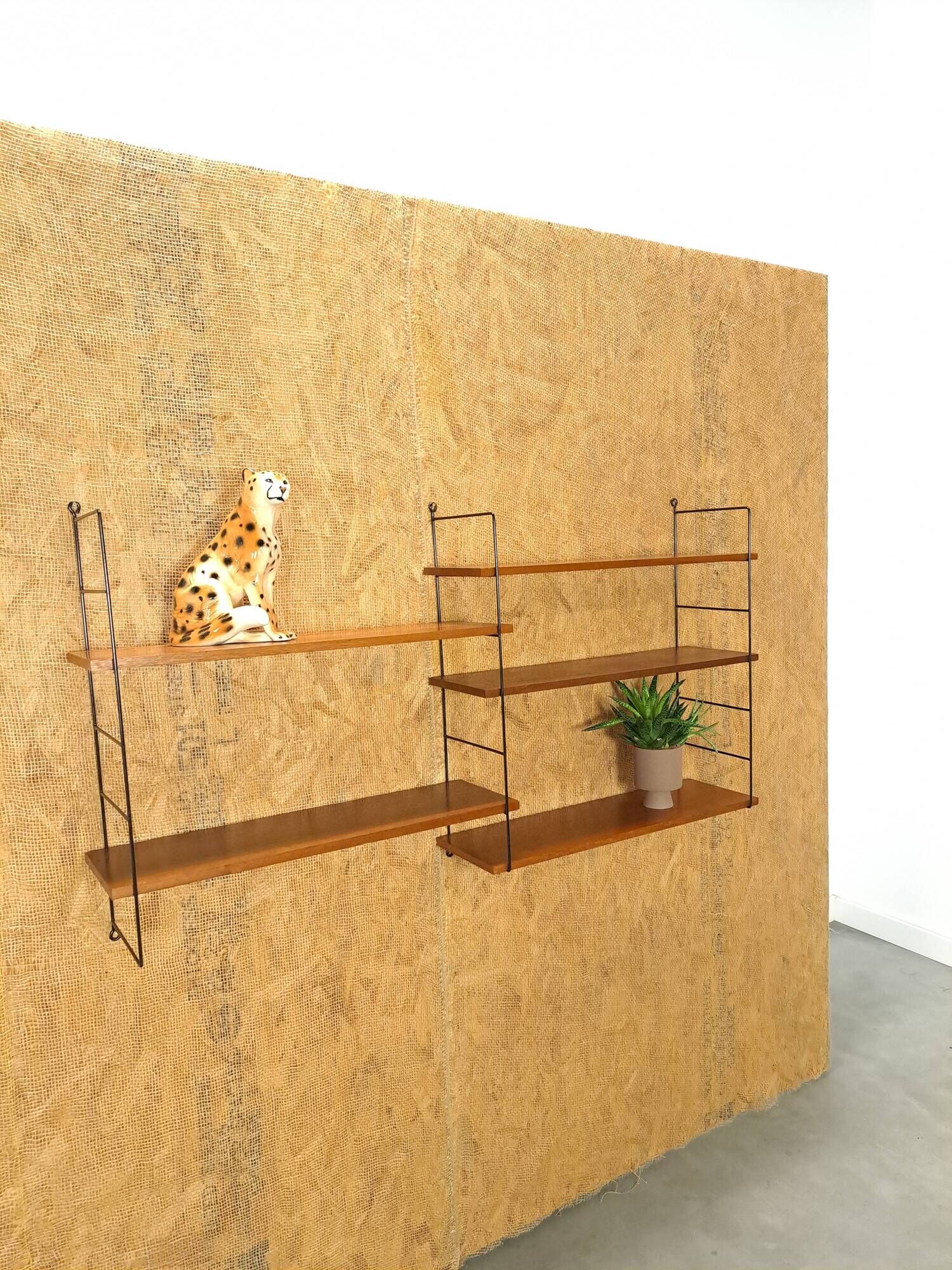 Wall rack with shelves and steel holders, dark wall system