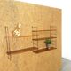 Wall rack with shelves and steel holders, dark wall system