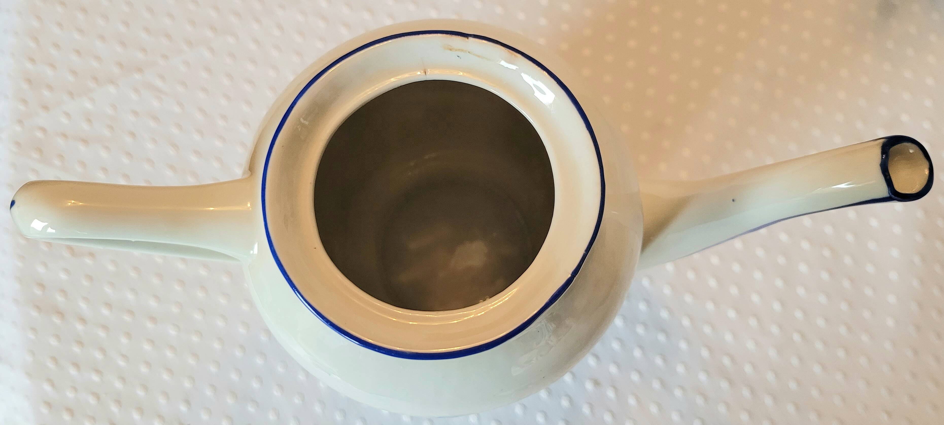 Blue and white ceramic coffee service with flowers.