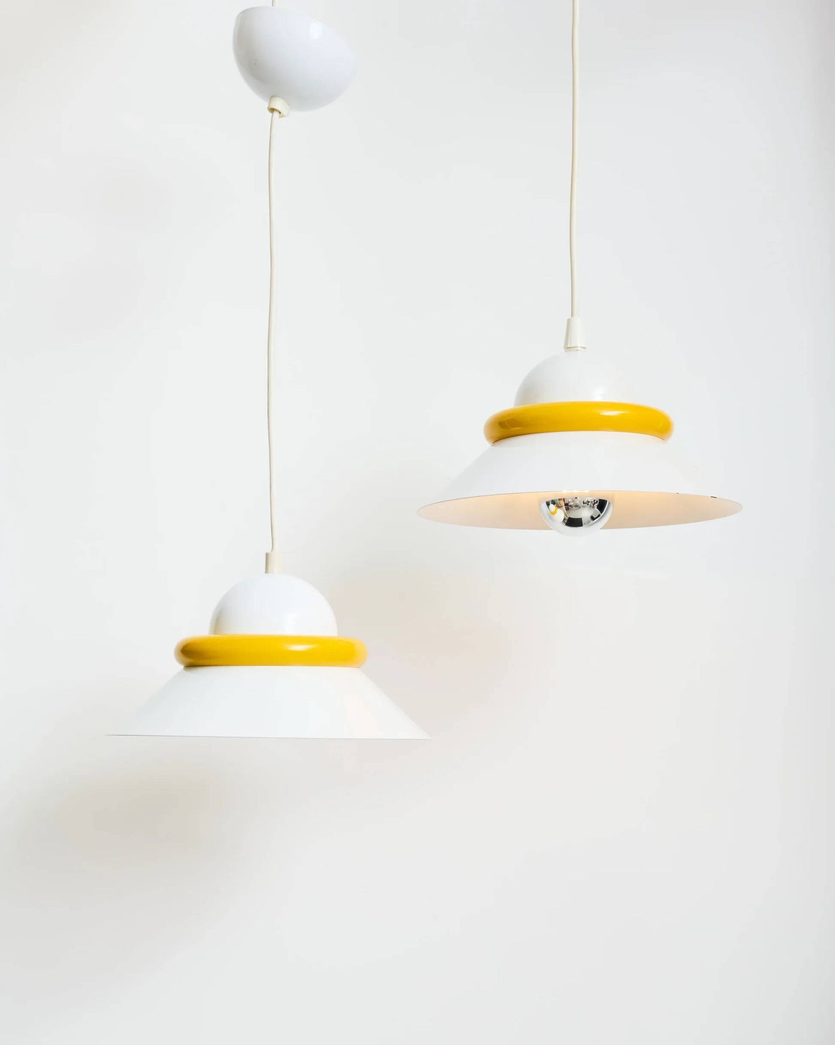 A pair of yellow and white two-tone suspensions, Italy, 1970s.