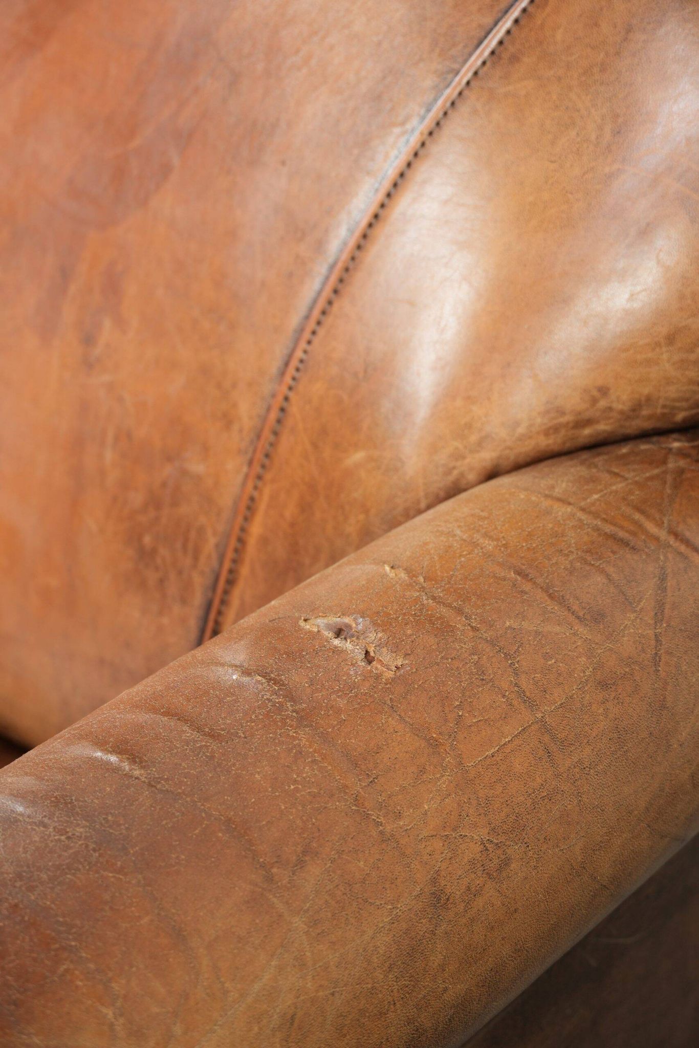 Sheepskin armchair with a beautiful vintage look and decorative nail finish