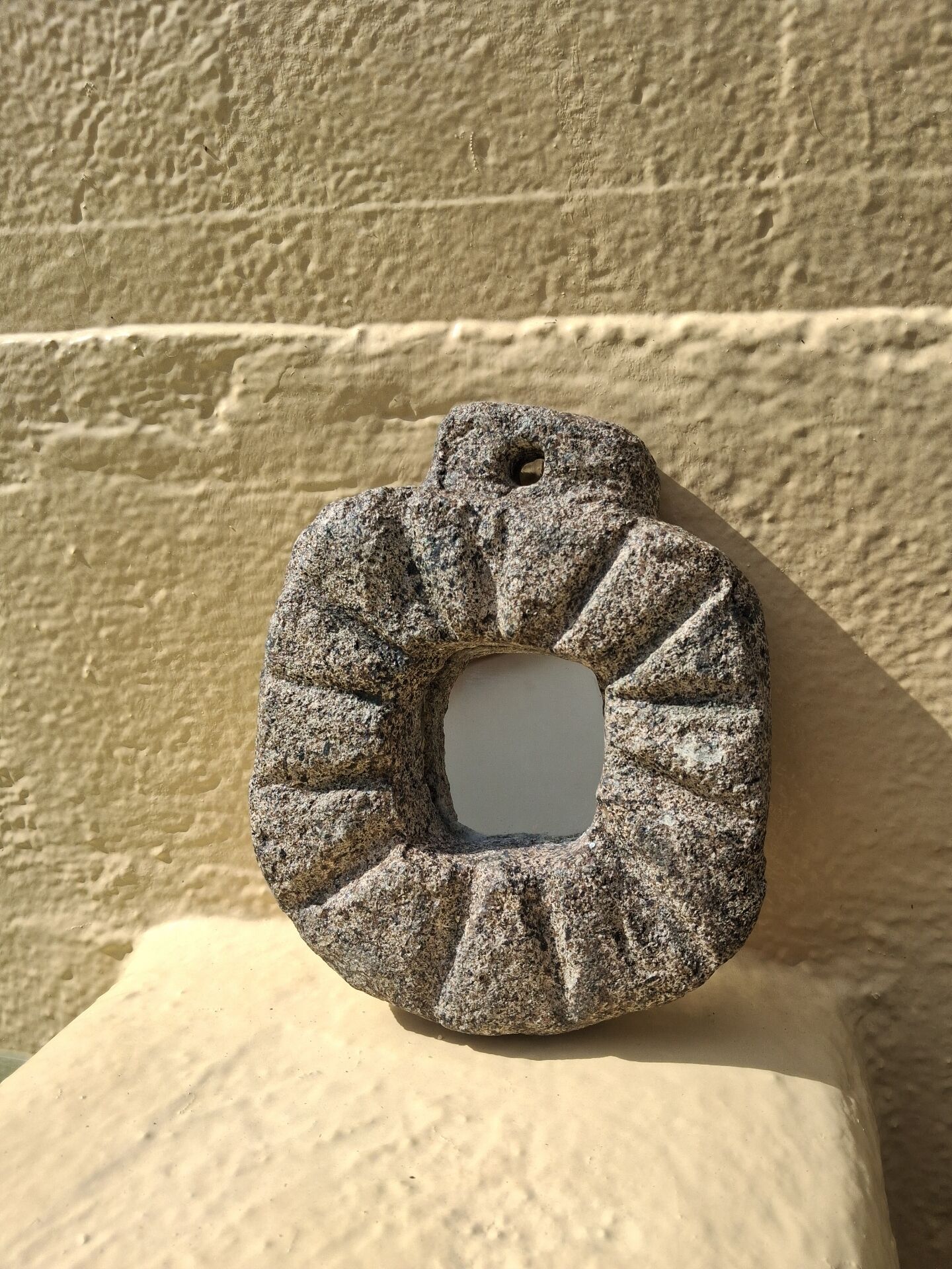 Brutalist mirror in hand-carved natural stone