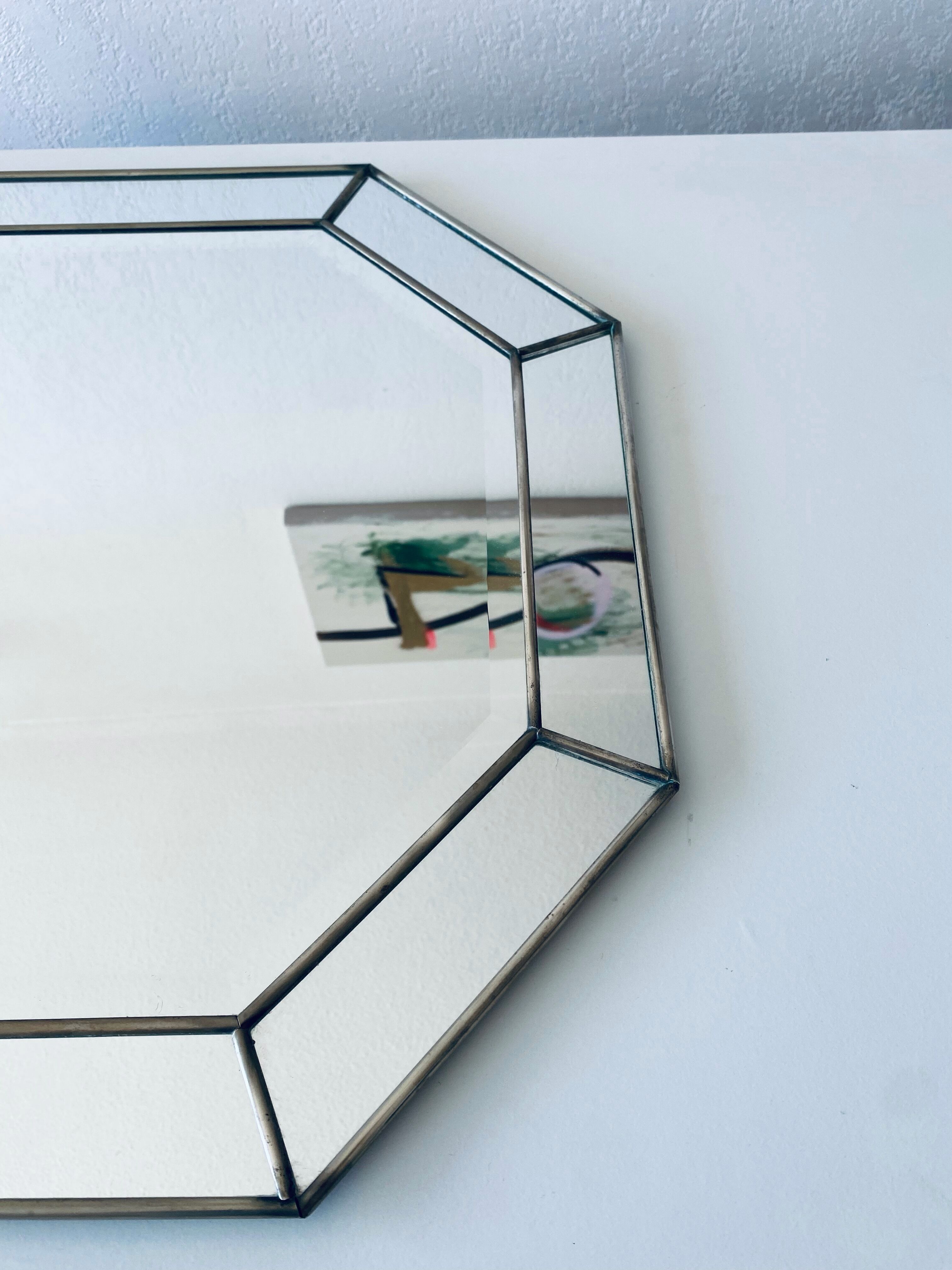 Old octagonal beveled mirror with parcloses