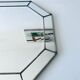 Old octagonal beveled mirror with parcloses