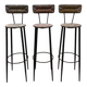 Suite de 3 tabourets de bar en acier et paillés