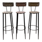 Suite de 3 tabourets de bar en acier et paillés