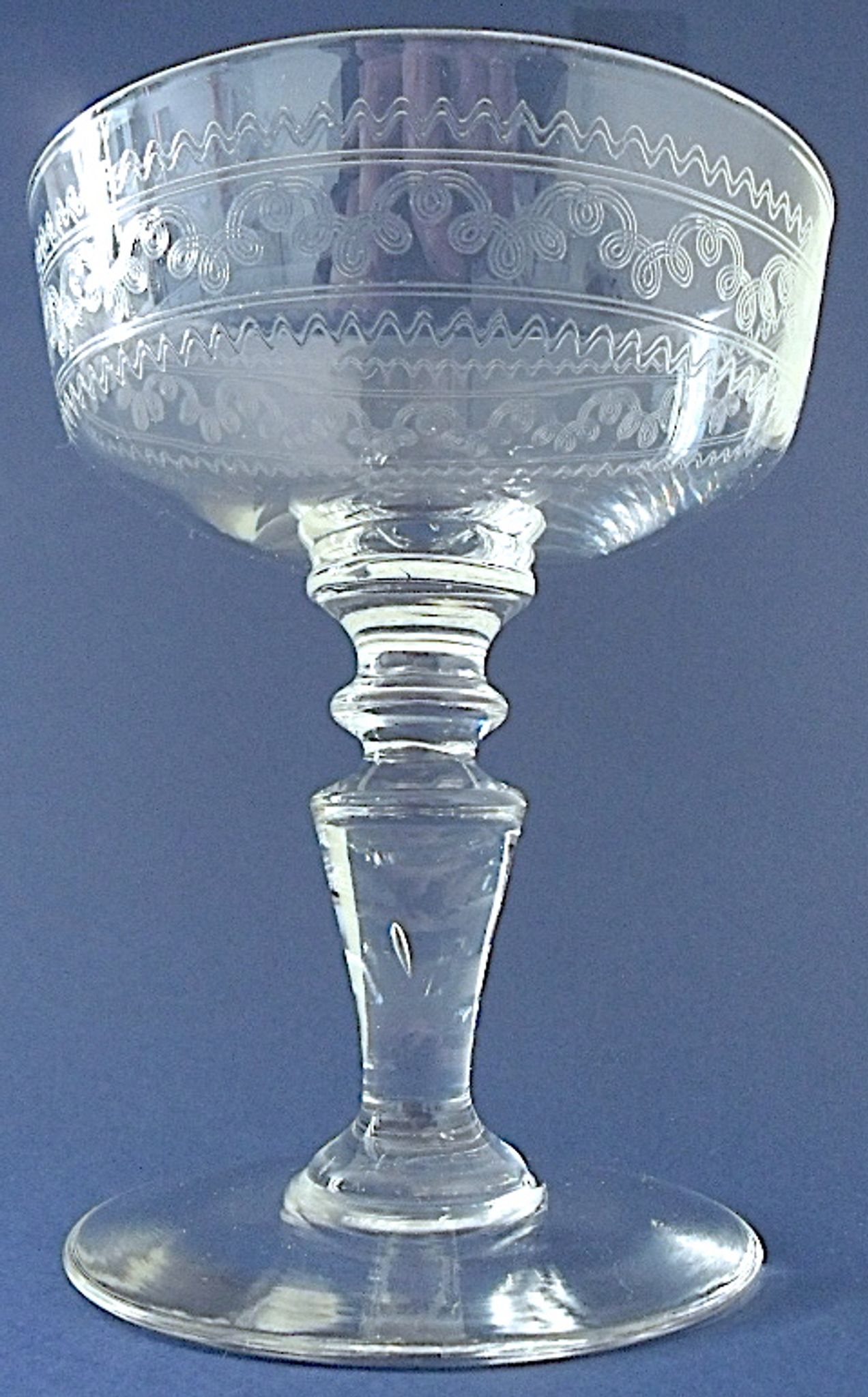 Suite of six champagne glasses on foot in engraved colorless crystal