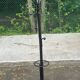 Vintage black metal coat rack with a white marble base.