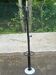 Vintage black metal coat rack with a white marble base.