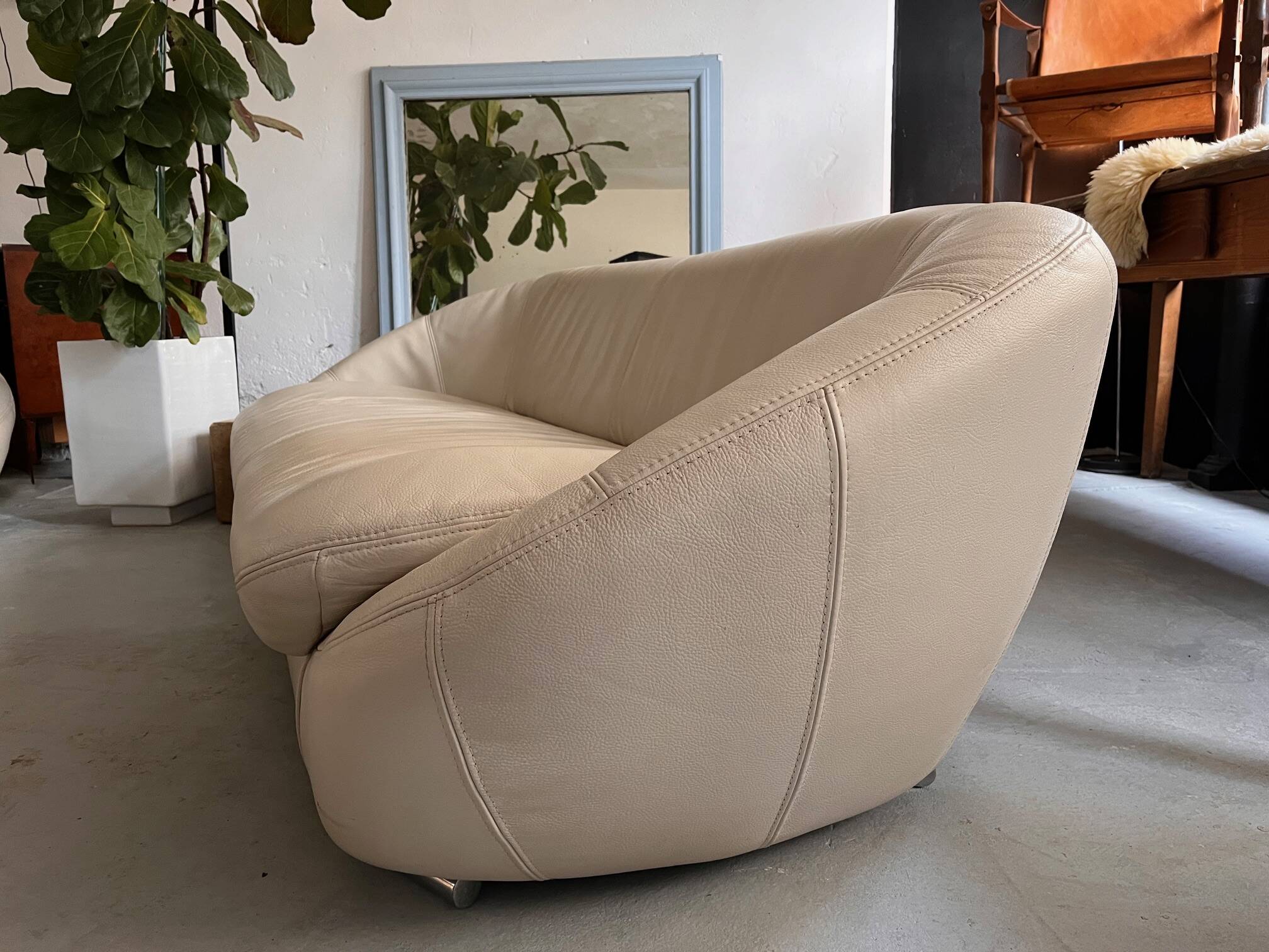 Rounded off-white leather sofa