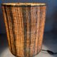 Small modernist table lamp with hand-woven shade.