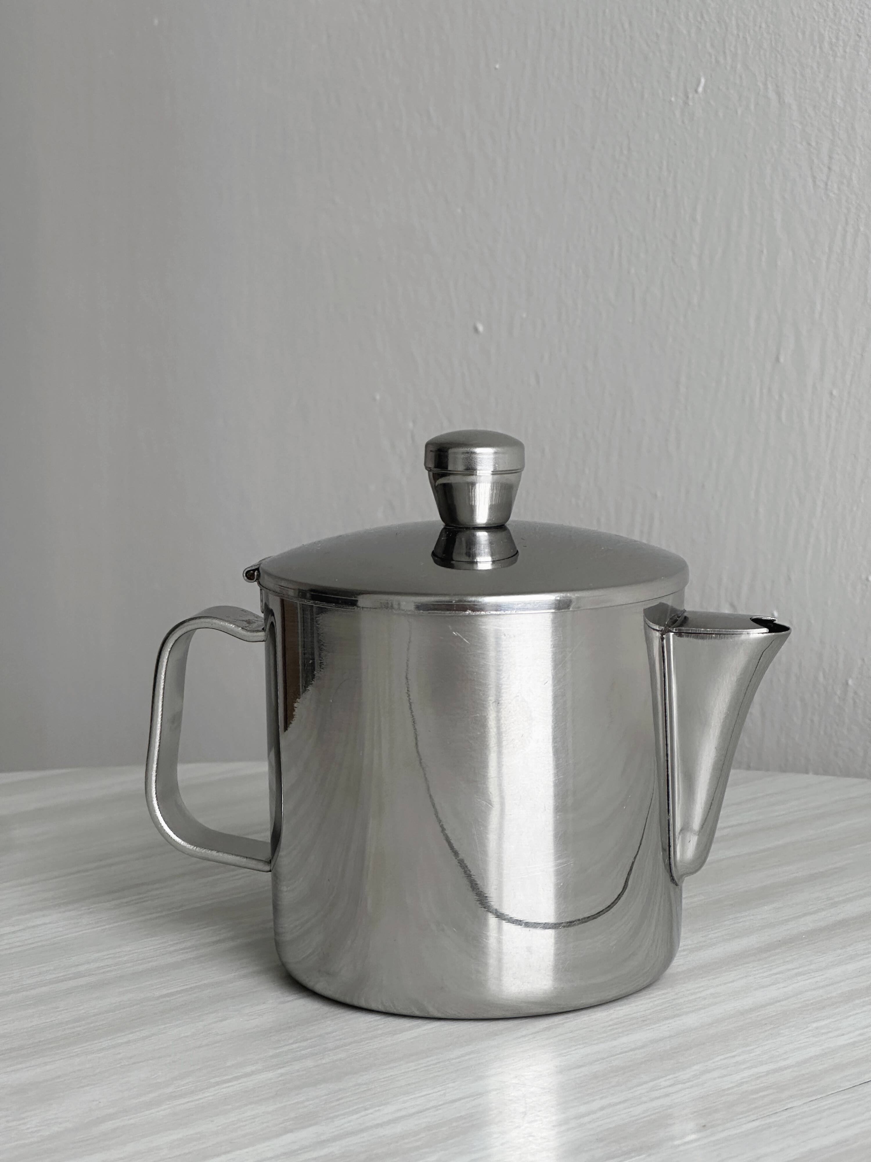 Small shiny stainless steel teapot